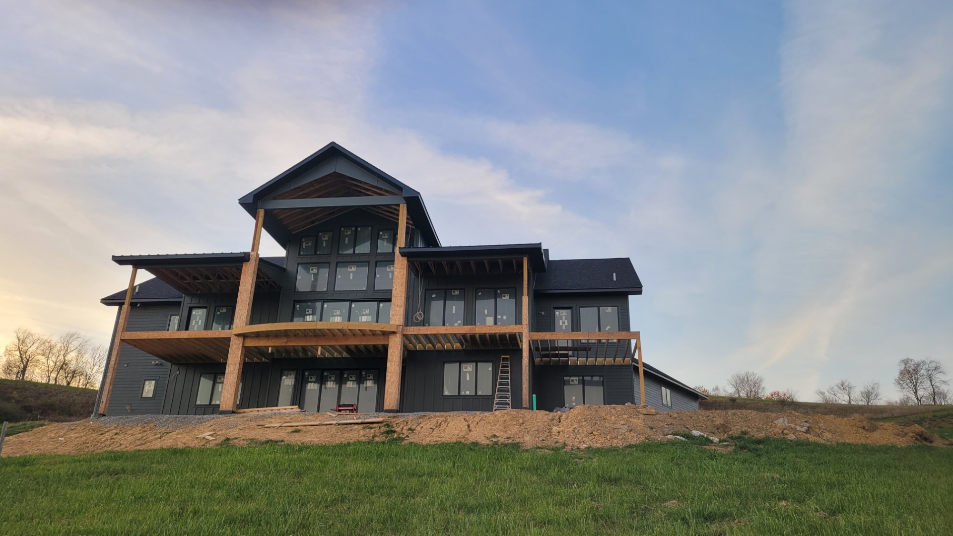 Custom home with dark board and batten siding installed by Paz Siding Contractors