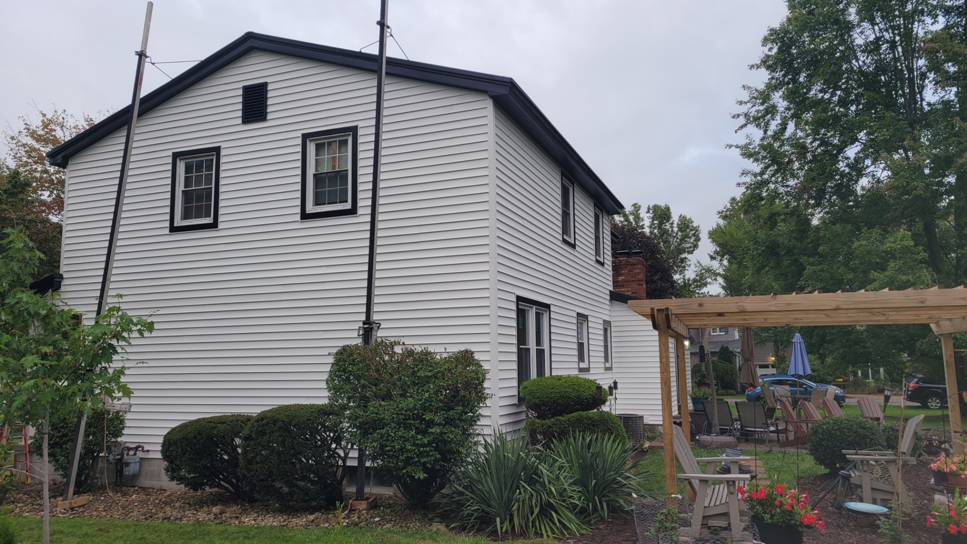 Residential home re-sided with white vinyl siding