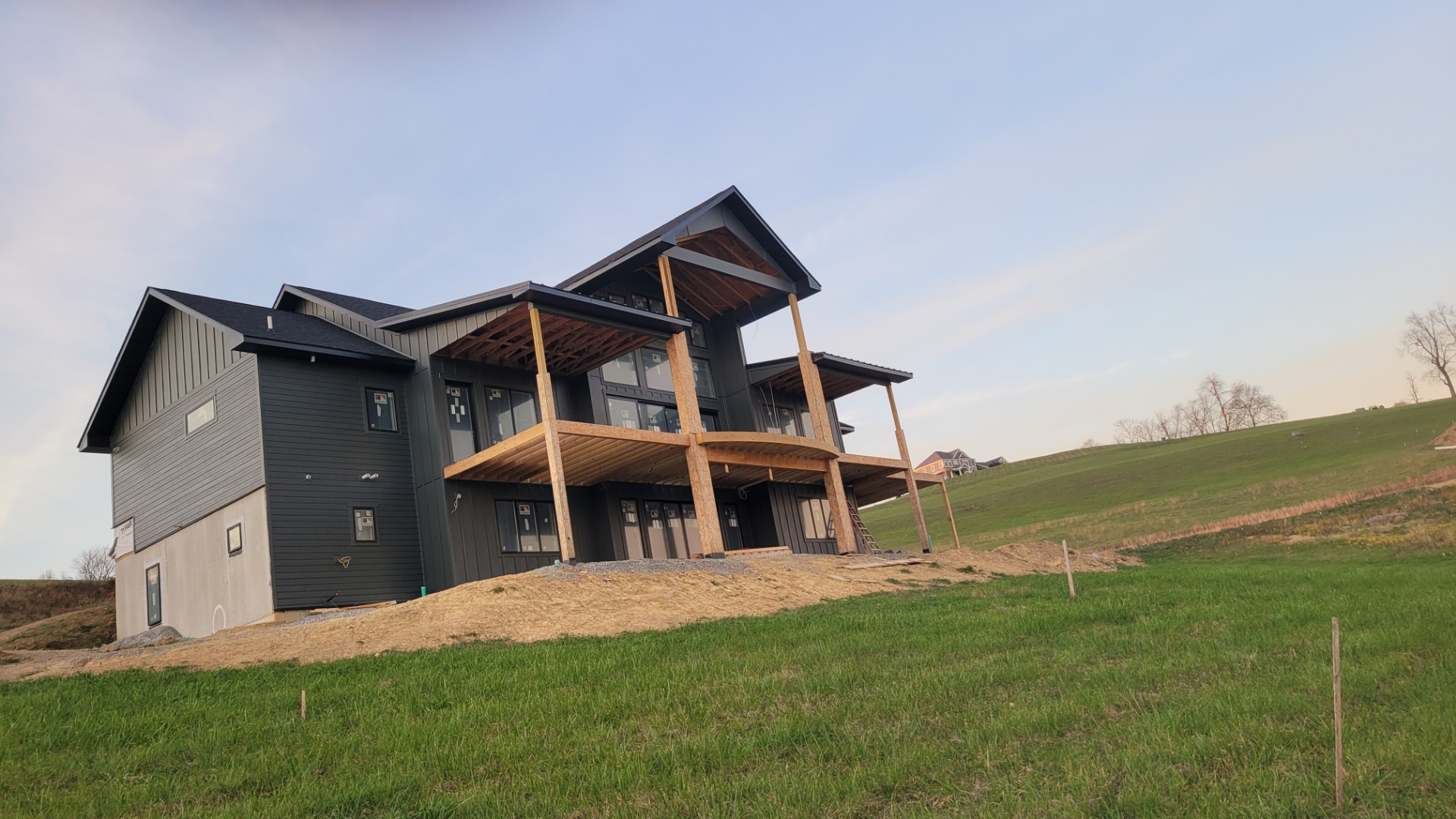 Modern custom home with board and batten siding and cantilevered roof