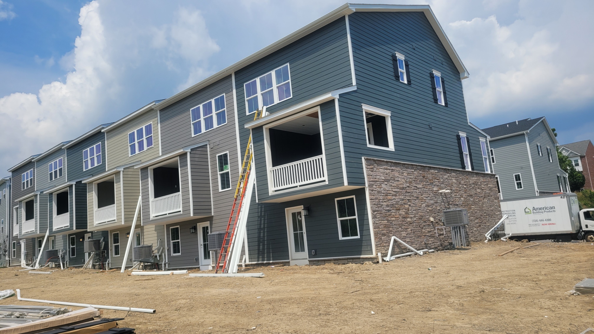 Townhome complex siding installation in progress