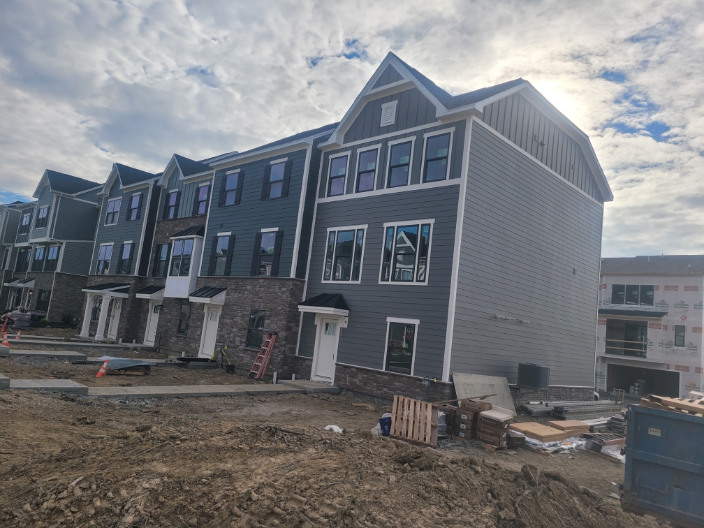 Townhome with stone base and siding installation
