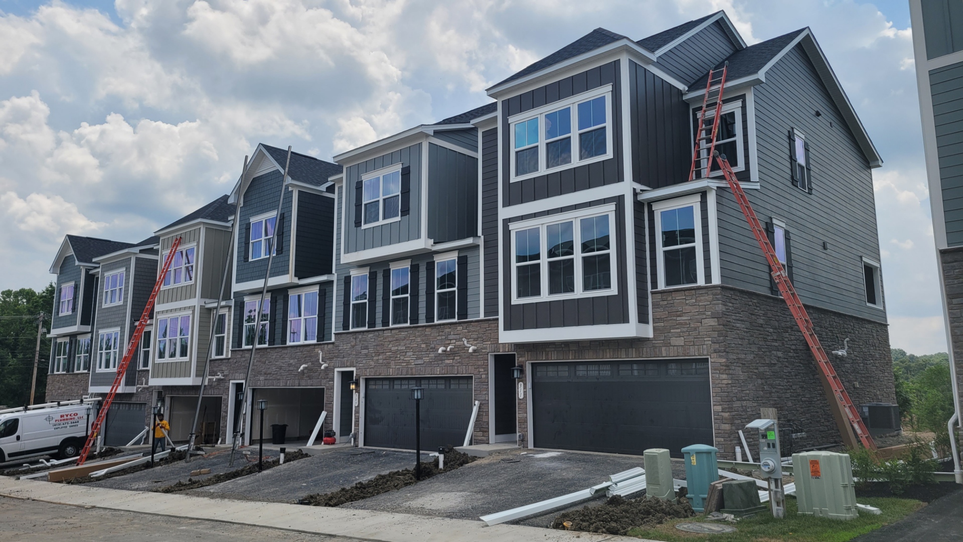 Luxury townhomes with stone base and board and batten siding
